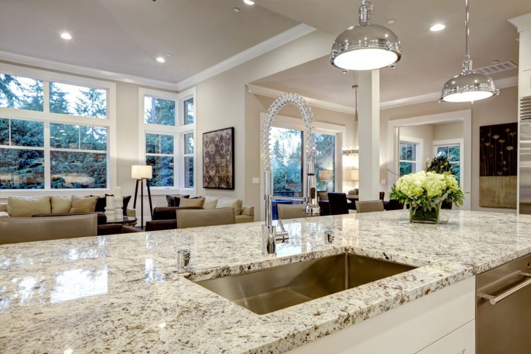 A kitchen sink with quartz counter tops,