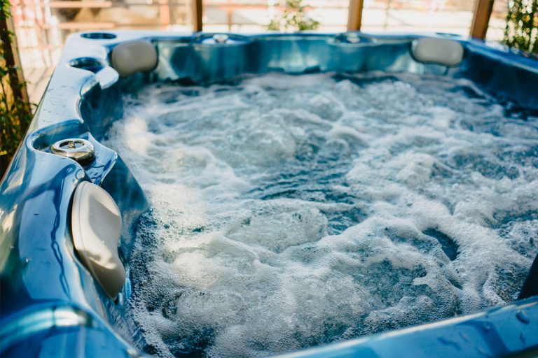 A blue hot tub outside.