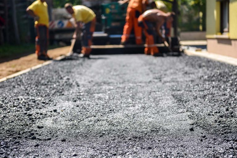An asphalt repair company working on a new asphalt driveway.