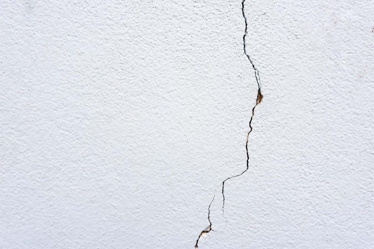 A crack in a white wall.