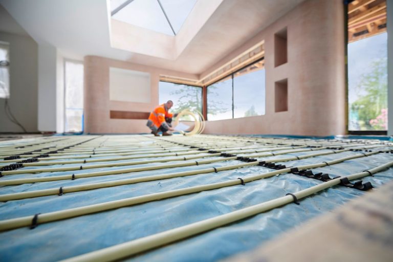 A contractor installing heated floors in a family home.