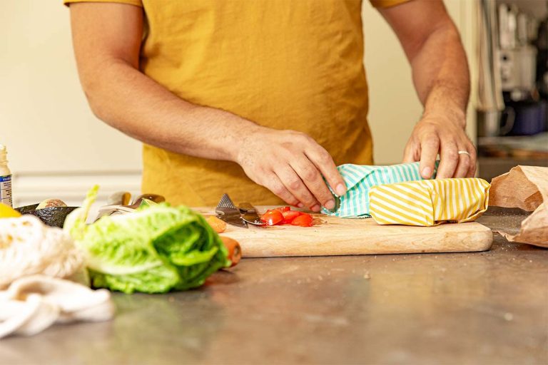 A person wrapping sandwiches in bees wax wrap.
